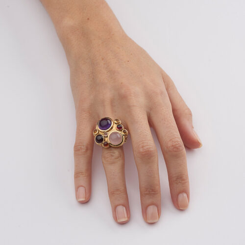 model wearing gold and multi gem stone cocktail ring