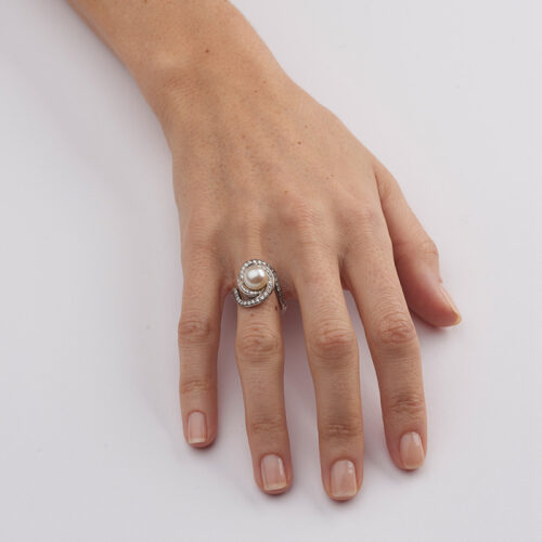 model wearing pearl and diamond swirl cocktail ring