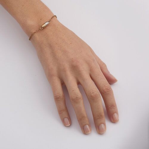 model wearing silver and gold pill bracelet