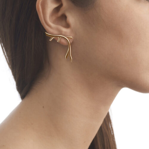 model wearing gold plated creeper earrings