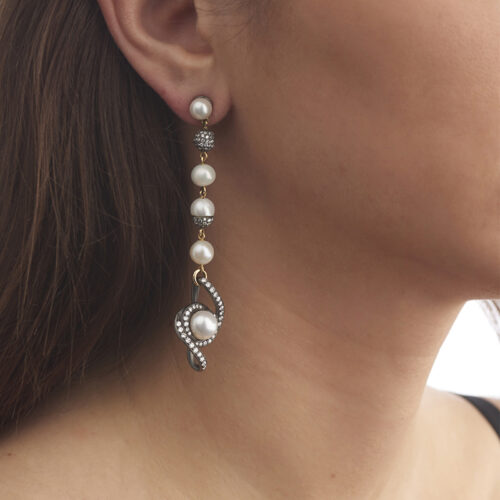 model wearing pearl and diamond earring