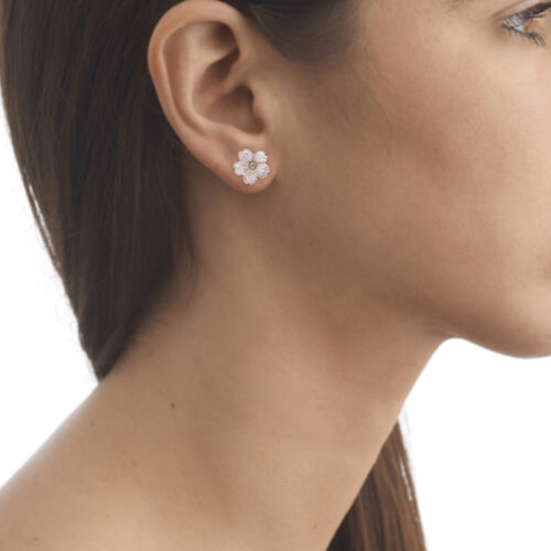 model wearing mother of pearl and diamond flower earrings